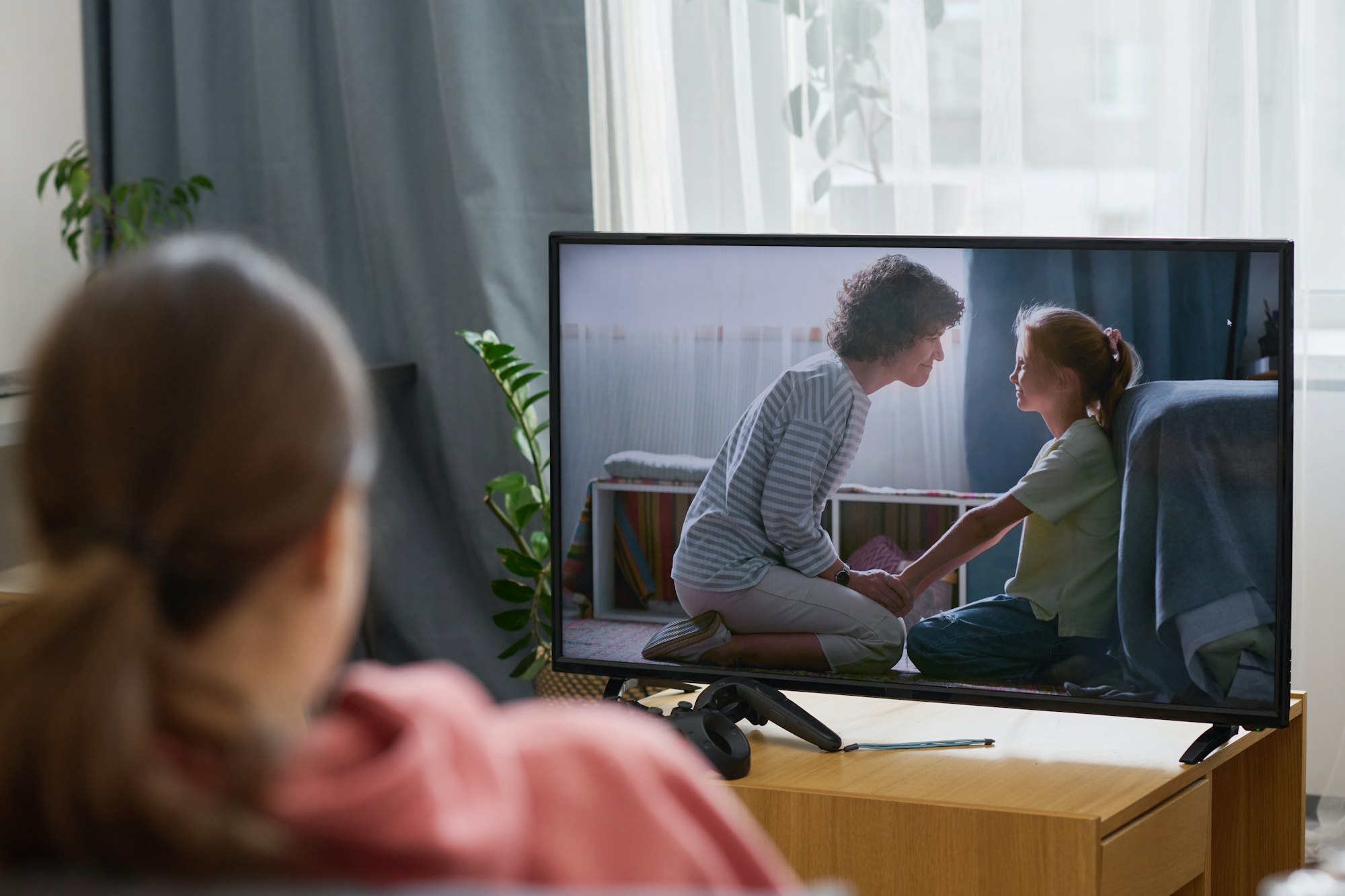 Girl watching TV at home